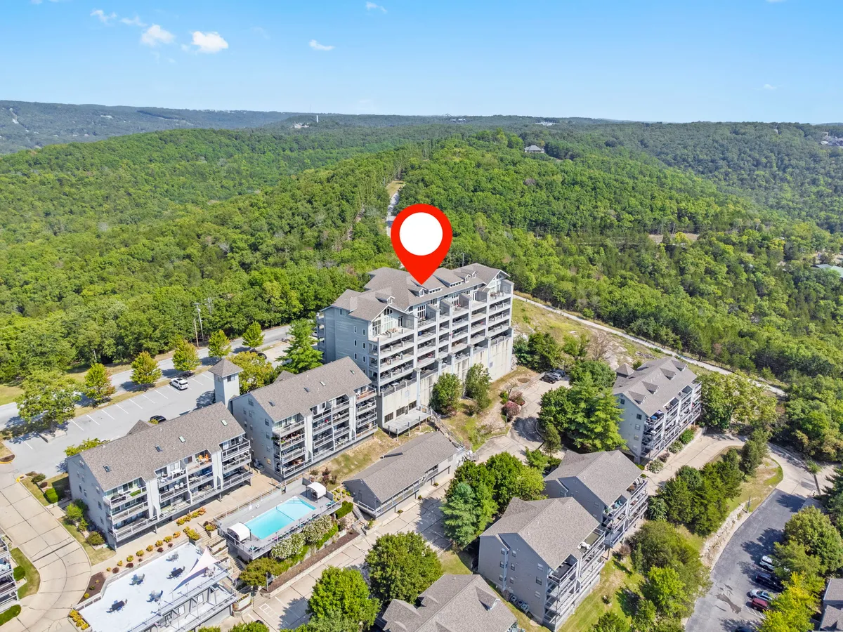 An inviting exterior image showing the main building, a sparkling swimming pool, and surrounding greenery. The overall feel is serene and family-friendly, with clear access to the pool and hints of outdoor trails, ideal for summer relaxation and outdoor gatherings.